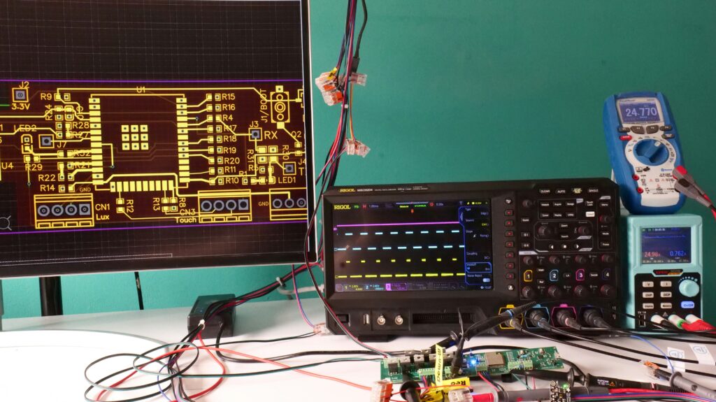 Electronics development and validation platform with PCB hardware, oscilloscope and laboratory test equipment.