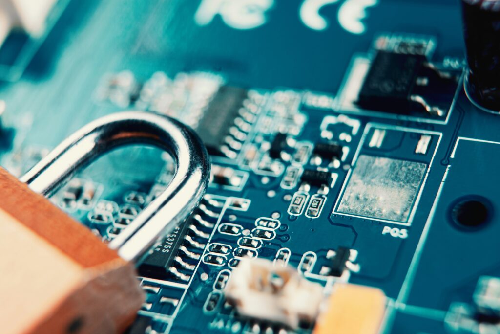 Padlock on a printed circuit board representing cybersecurity and data protection.