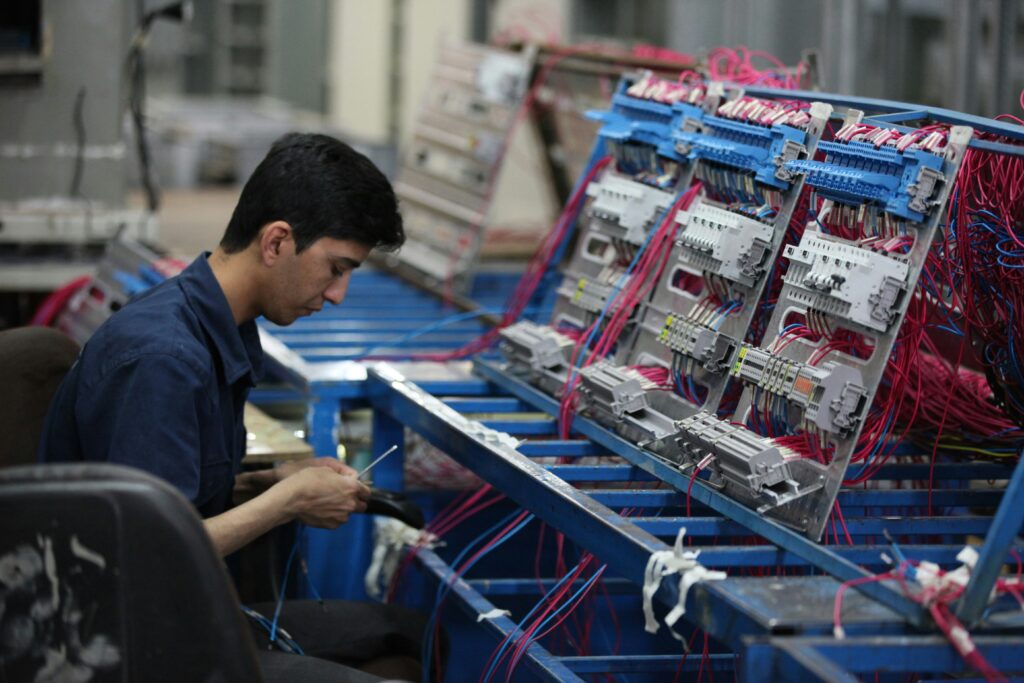Electronic assembly technician wiring and assembling electrical control systems in a manufacturing environment.